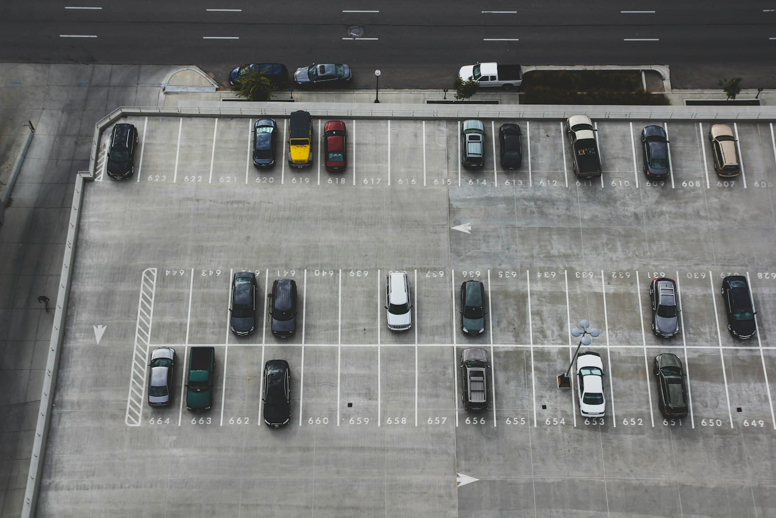Aerial view of a parking lot with painted stalls and an accessible space