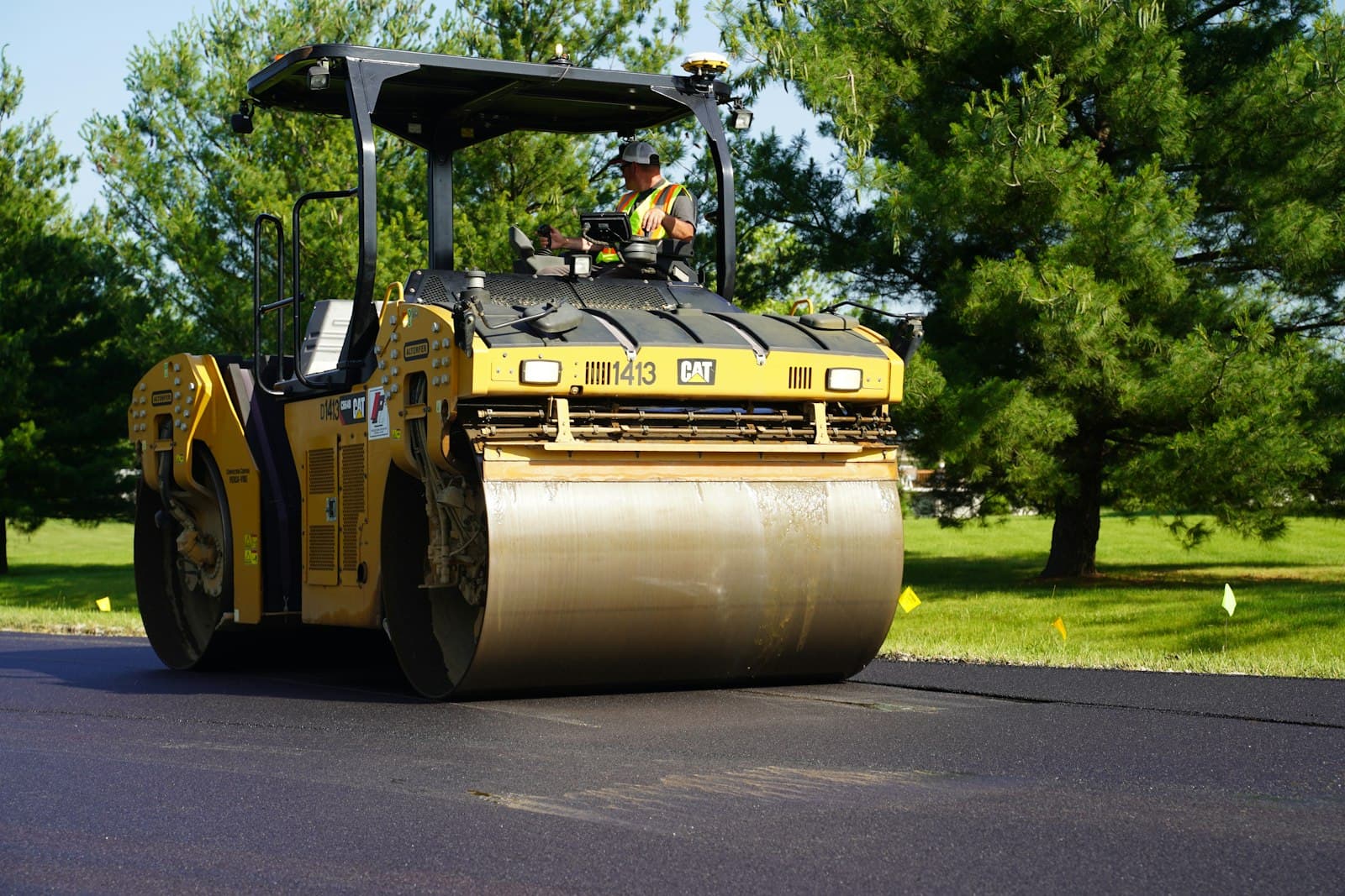 A road roller compacting fresh asphalt