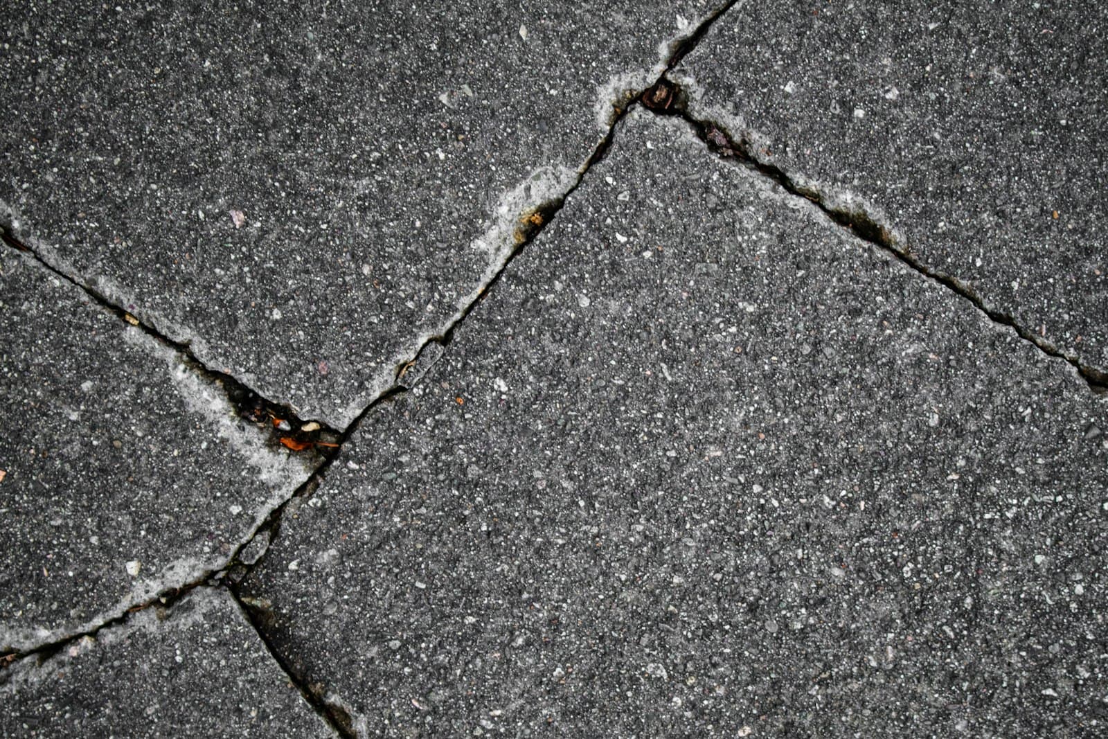 Cracked and broken asphalt pavement in need of repair