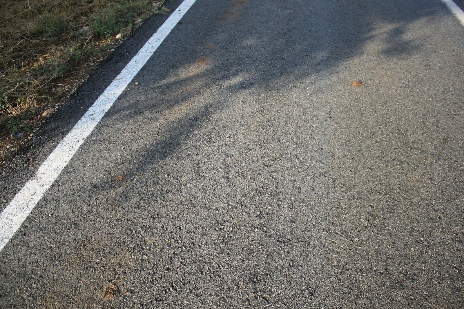 Close view of asphalt surface with a white painted line